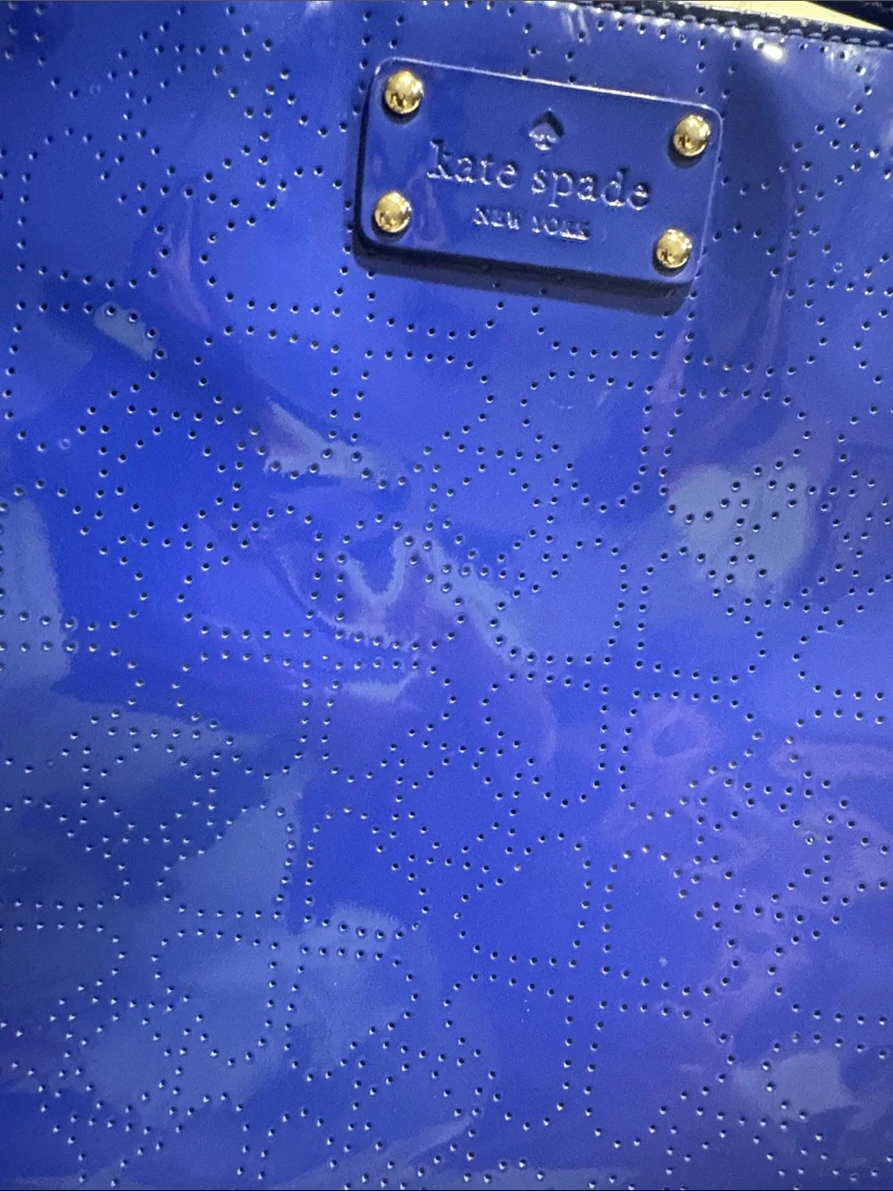 Kate Spade heart perforated patent leather crossbody in cobalt blue.